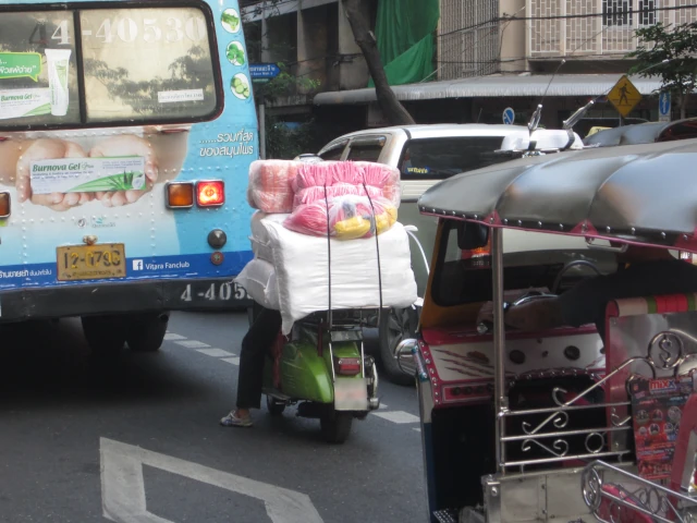 バンコクの渋滞に巻き込まれるバスとバイクとトゥクトゥク